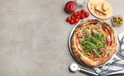 Tasty pizza with meat and arugula on grey table, flat lay. Space for text