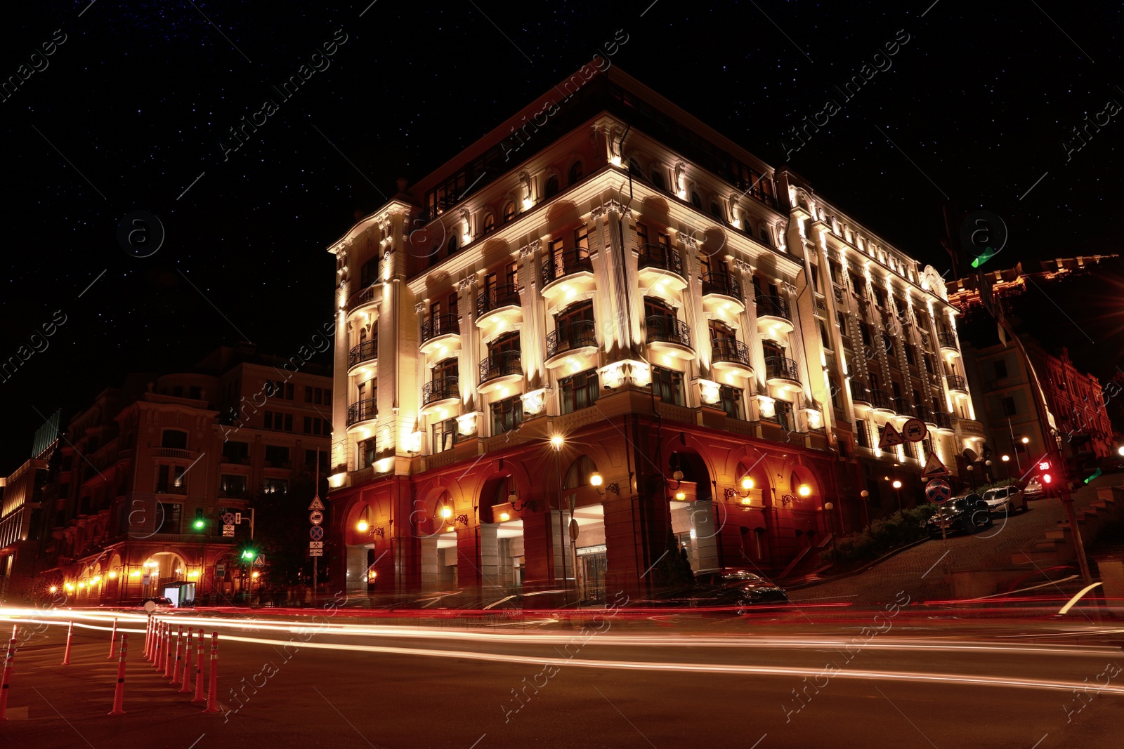 Photo of View of night cityscape with illuminated building and light trails