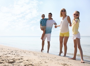 Photo of Happy family at beach on sunny summer day