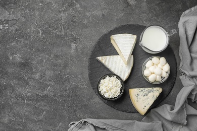 Photo of Fresh dairy products on gray background, top view