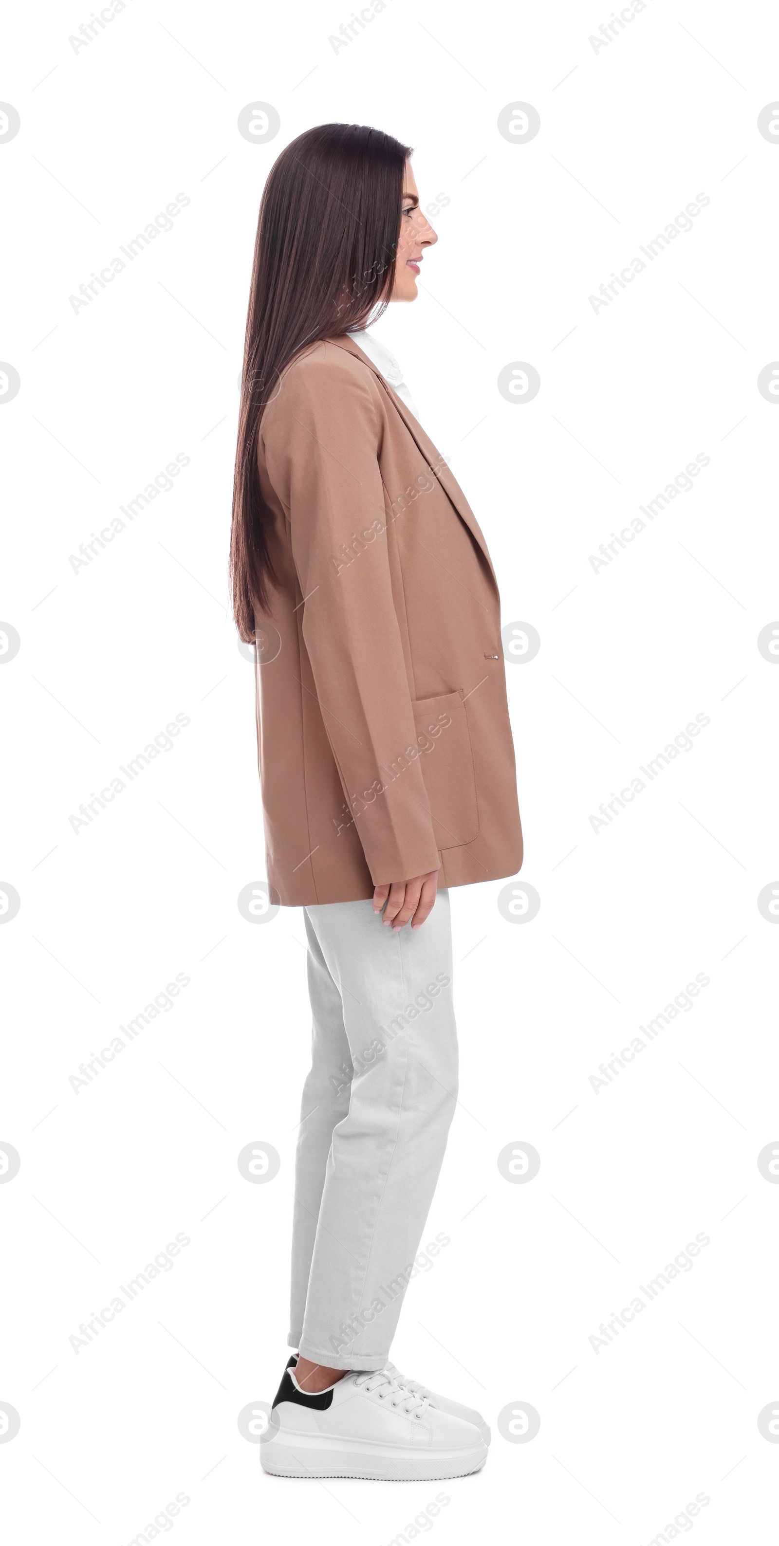 Photo of Young businesswoman in suit standing on white background