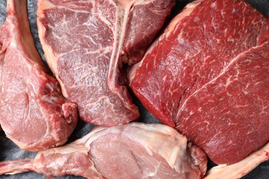 Fresh raw beef cuts on table, top view