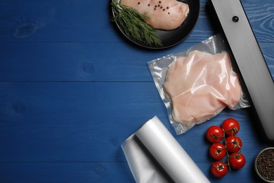 Photo of Sealer for vacuum packing and plastic bag with meat on blue wooden table, flat lay. Space for text