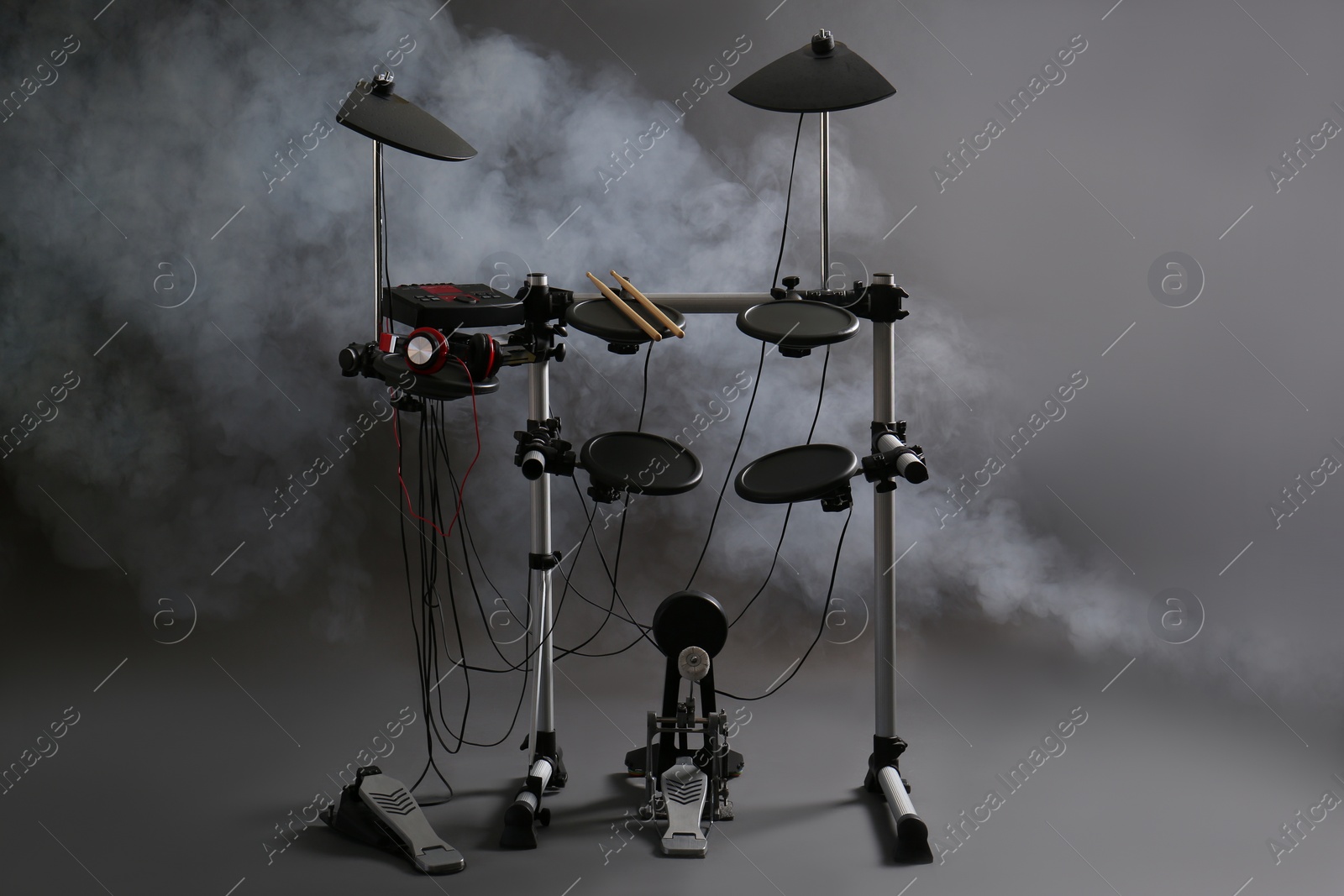 Photo of Modern electronic drum kit and smoke on grey background. Musical instrument