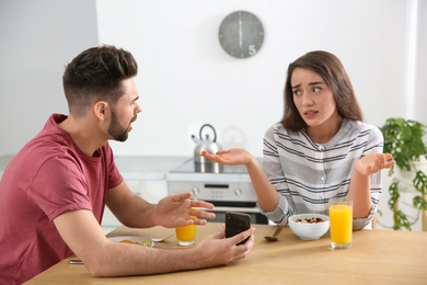 Photo of Young couple arguing at home. Problems in relationship