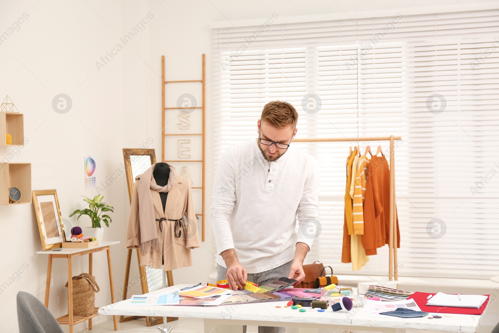 Photo of Fashion designer creating new clothes in studio