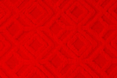 Soft red carpet with pattern as background, top view