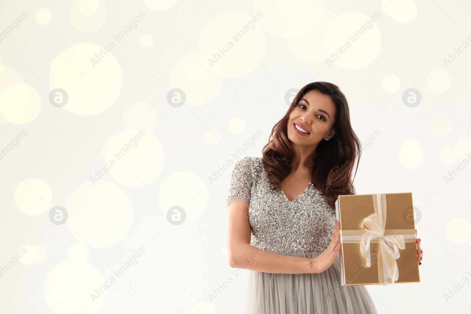 Photo of Beautiful woman with Christmas gift on white background