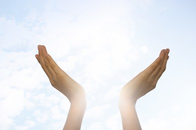 Photo of Feeling freedom. Woman reaching for sky on sunny day, closeup of hands Space for text