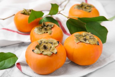 Photo of Delicious ripe juicy persimmons on table, closeup