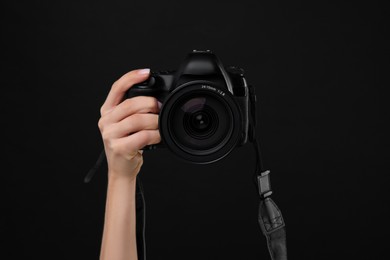 Photo of Photographer with camera on black background, closeup