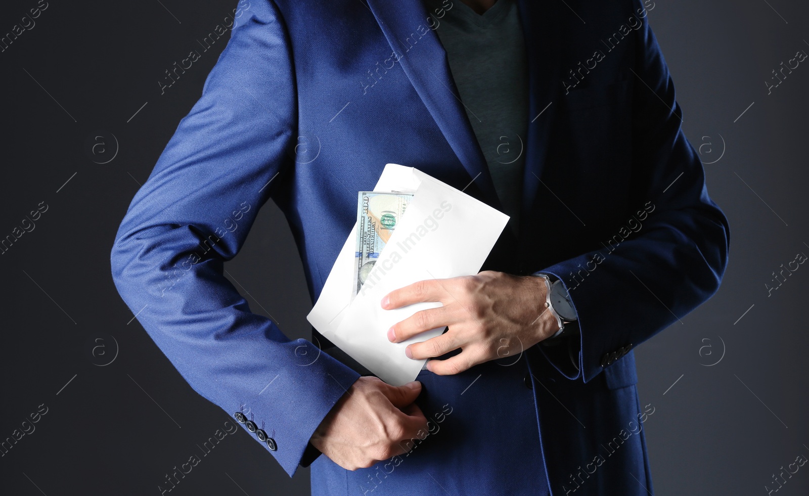 Photo of Man putting bribe money into pocket on black background, closeup