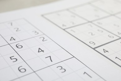 Photo of Sudoku puzzle grids on table, closeup view