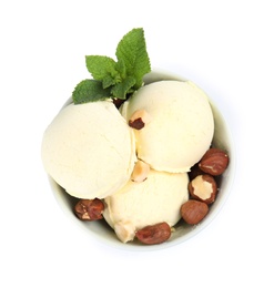 Delicious vanilla ice cream with hazelnuts and mint in dessert bowl on white background, top view