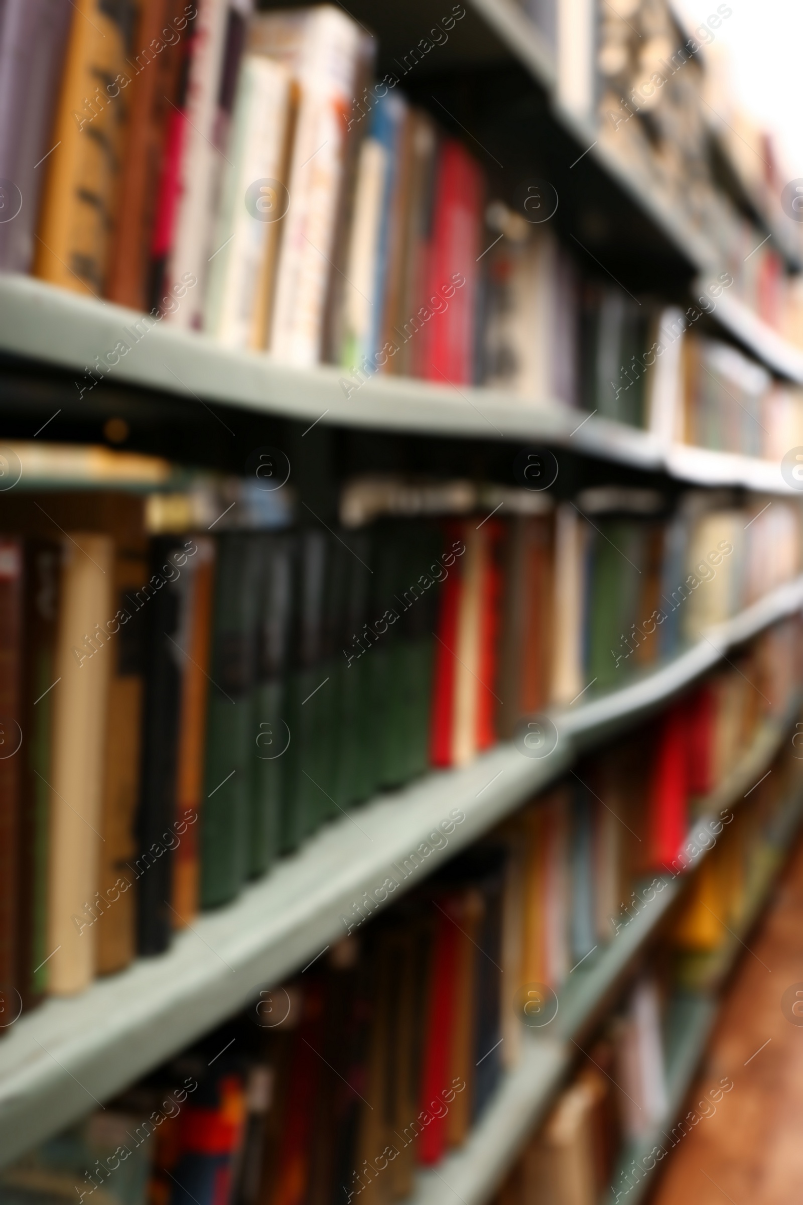 Photo of Blurred view of books on shelves in library