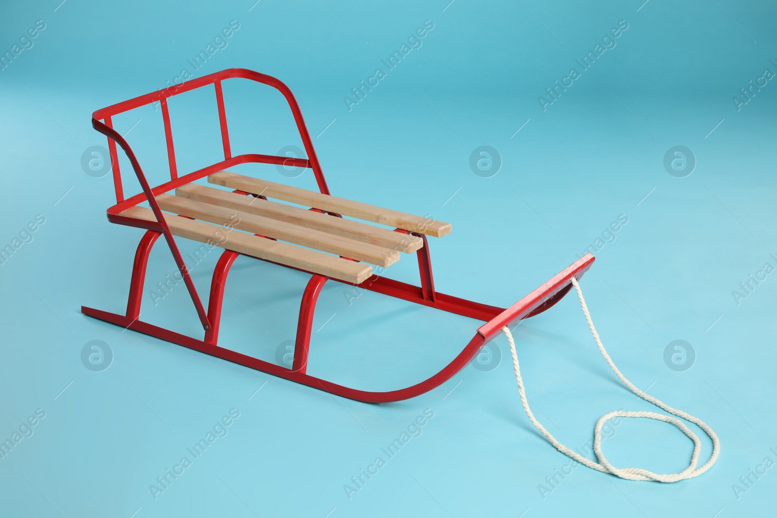 Photo of Sleigh on light blue background. Winter outdoor activity