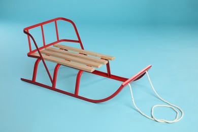 Photo of Sleigh on light blue background. Winter outdoor activity