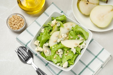 Photo of Fresh salad with pear served on light table, flat lay