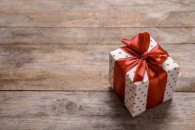 Beautiful gift box on wooden background