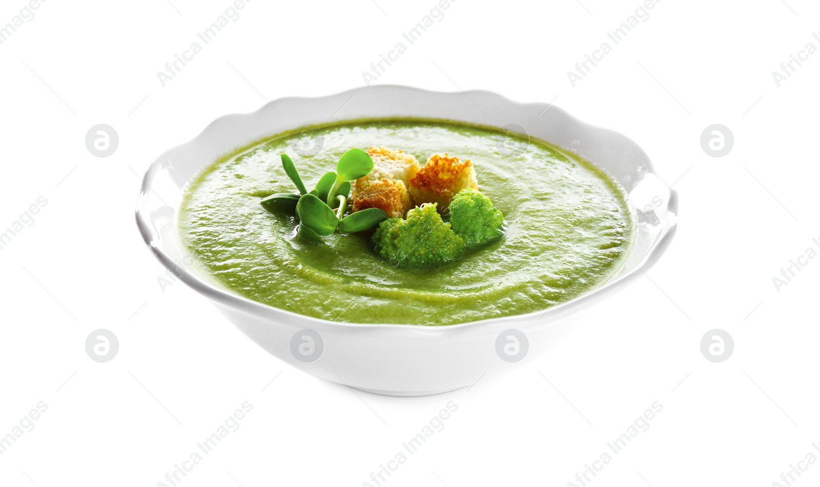 Photo of Bowl of broccoli cream soup with croutons on white background