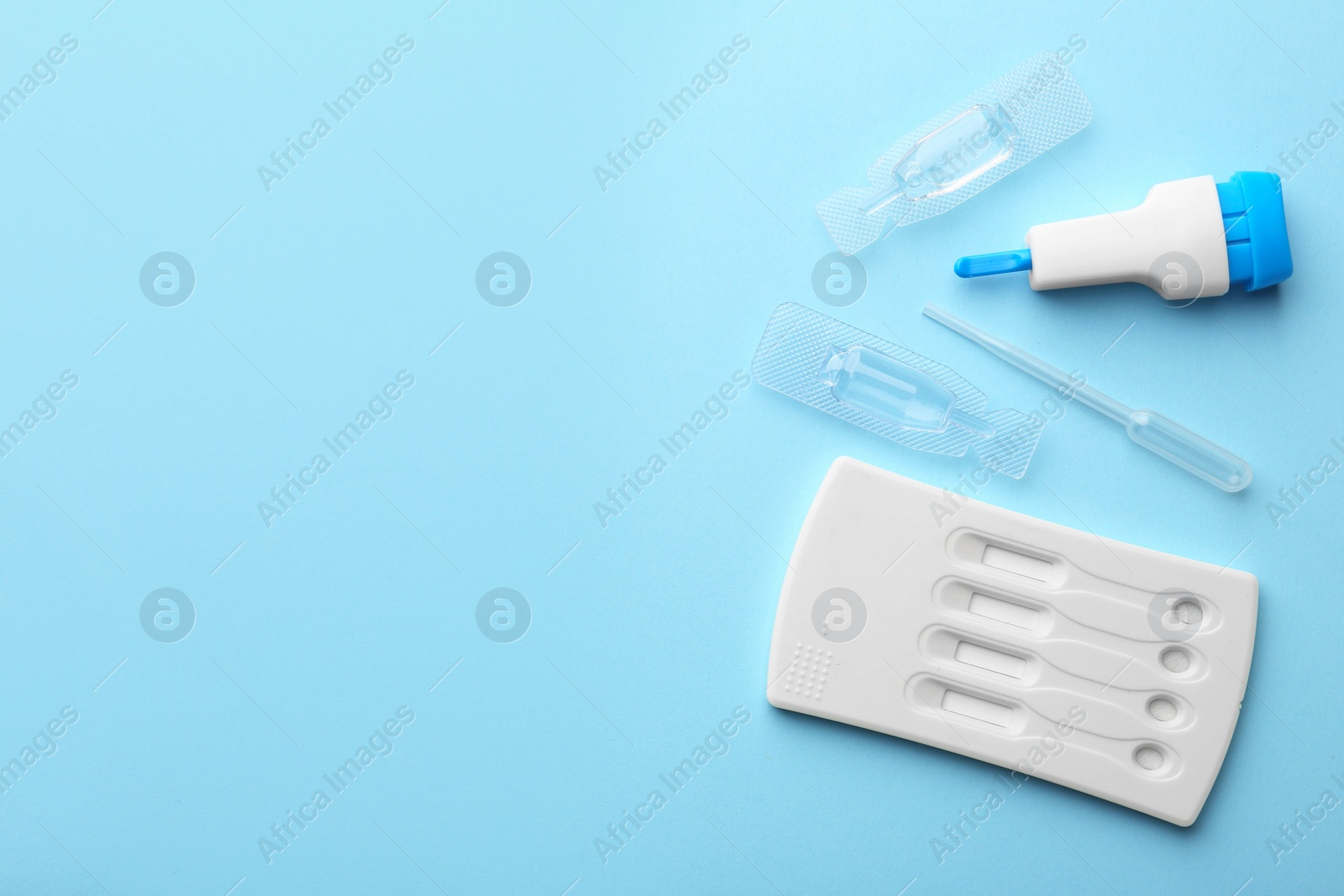 Photo of Disposable express test kit on light blue background, flat lay. Space for text