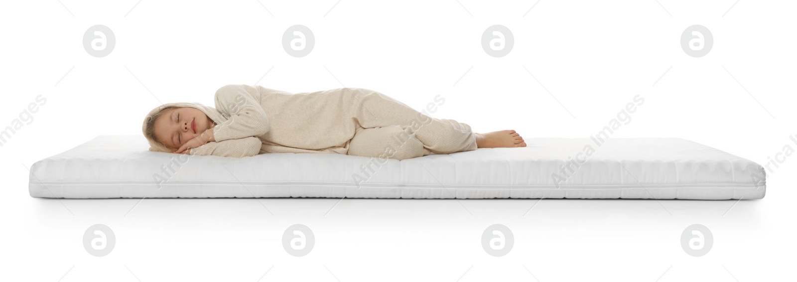 Photo of Little girl sleeping on comfortable mattress against white background