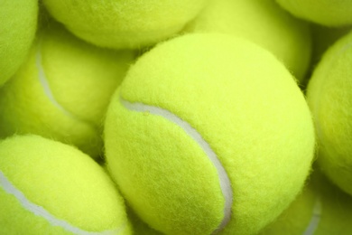 Tennis balls as background, closeup. Sports equipment