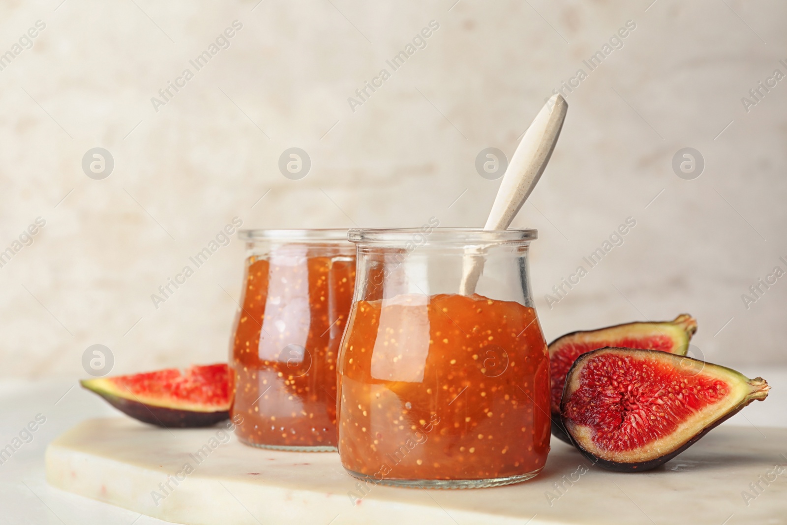 Photo of Homemade delicious fig jam on white table