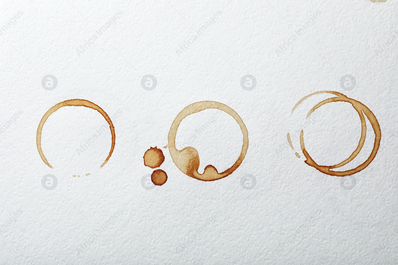 Photo of Dried coffee cup stains on white background, top view