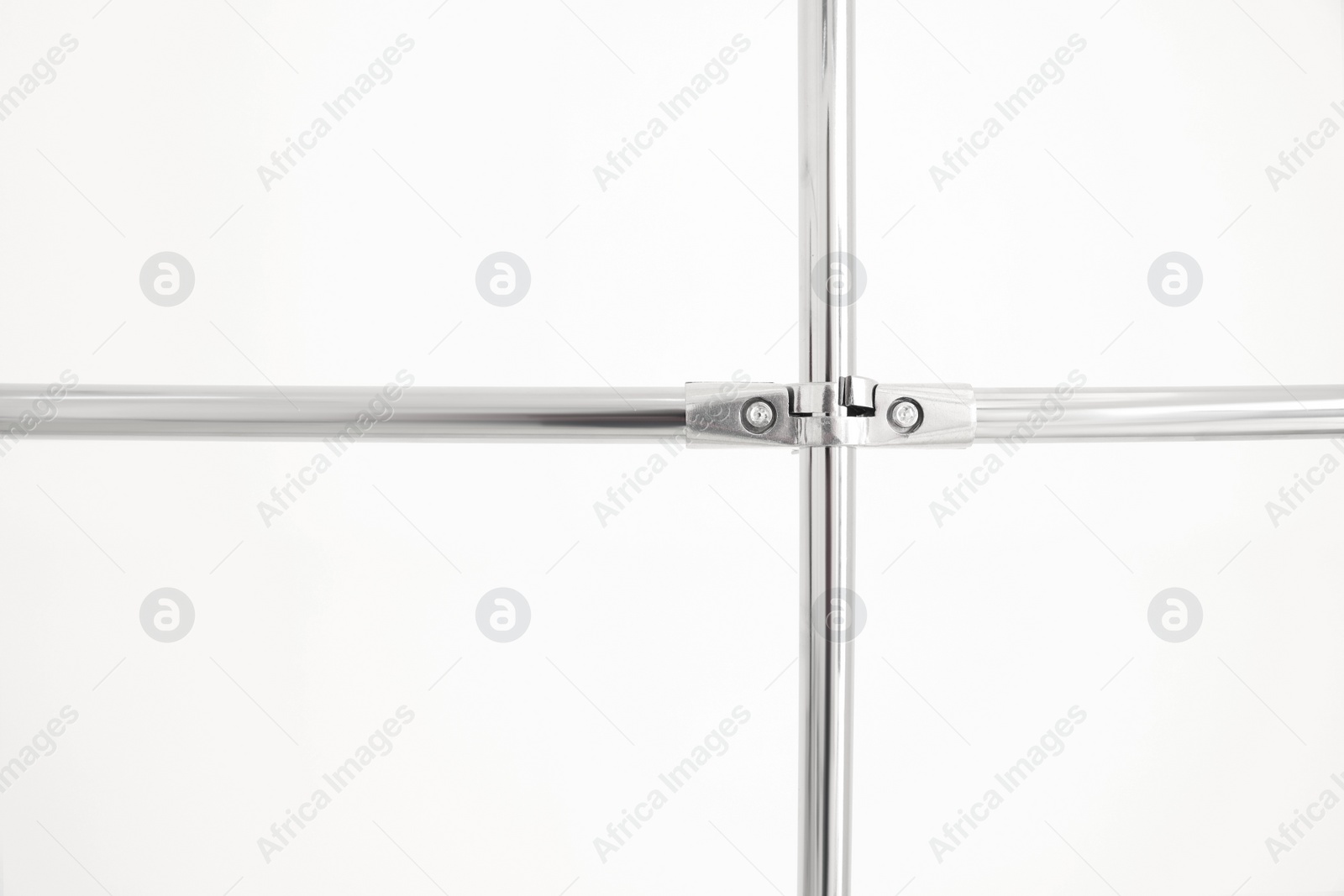Photo of New modern metal pipes against white background