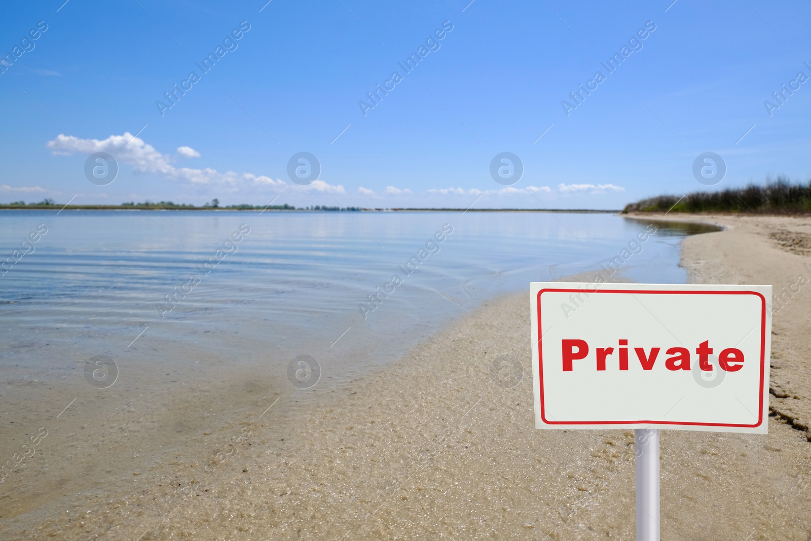 Image of Sign with word Private on sandy beach near river