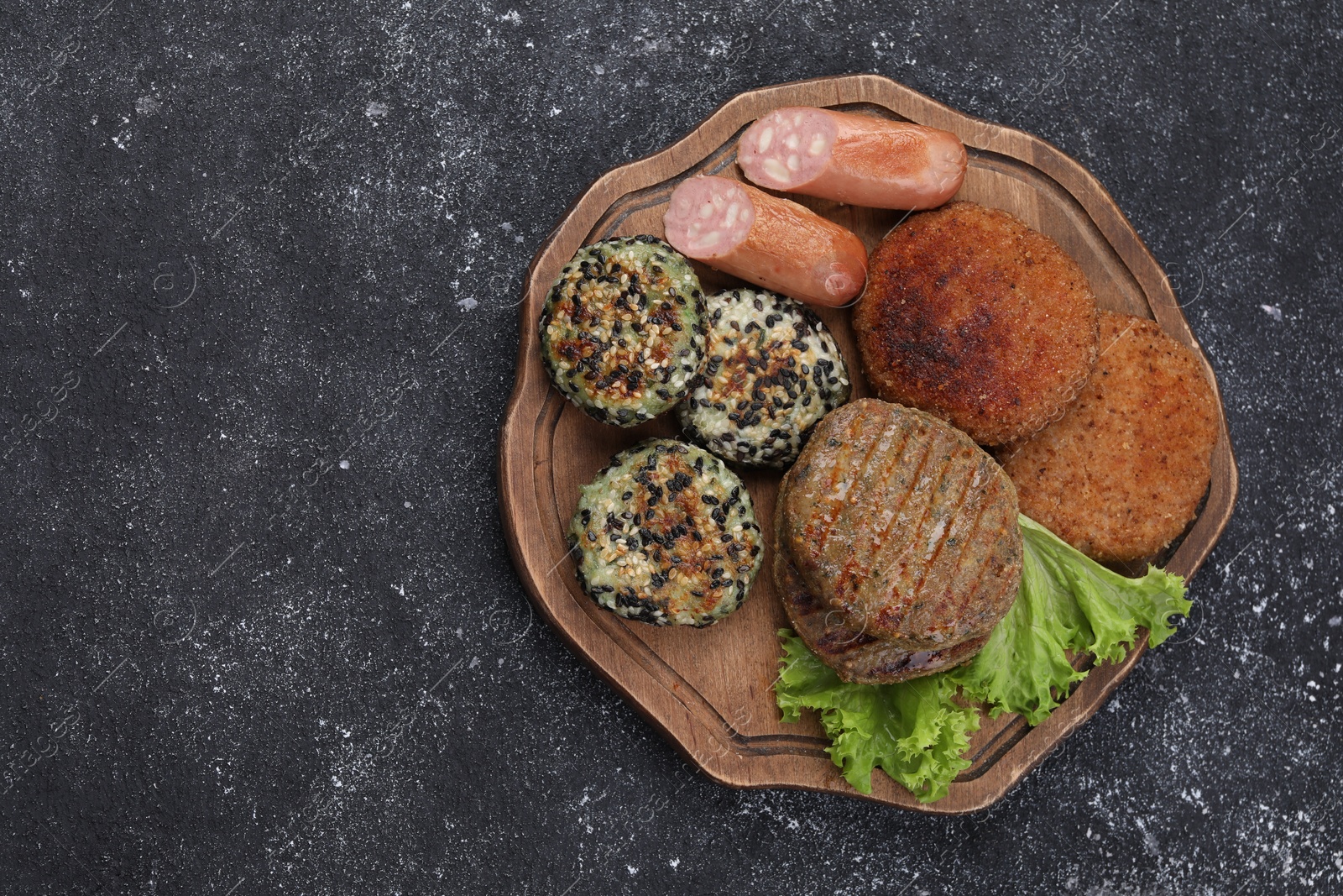 Photo of Different tasty vegan meat products on grey table, top view. Space for text