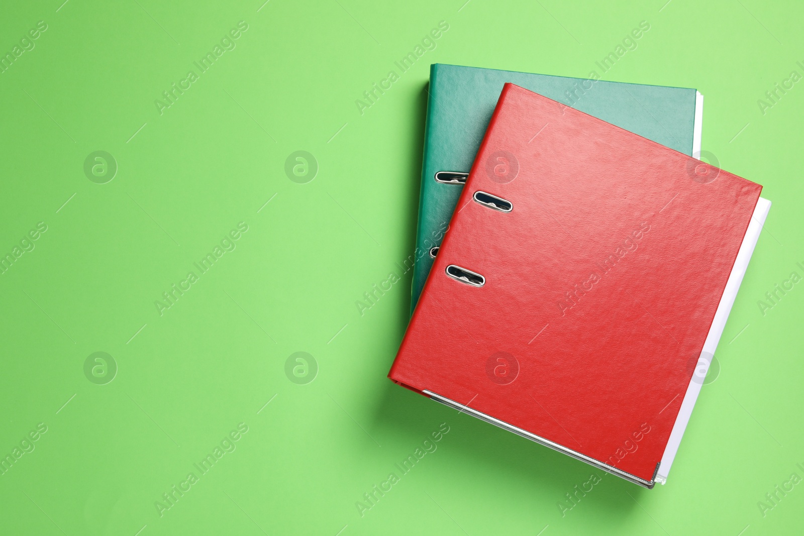 Photo of Office folders on light green background, flat lay. Space for text