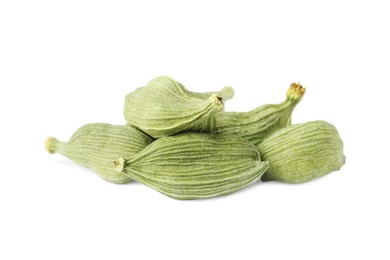 Pile of dry green cardamom on white background