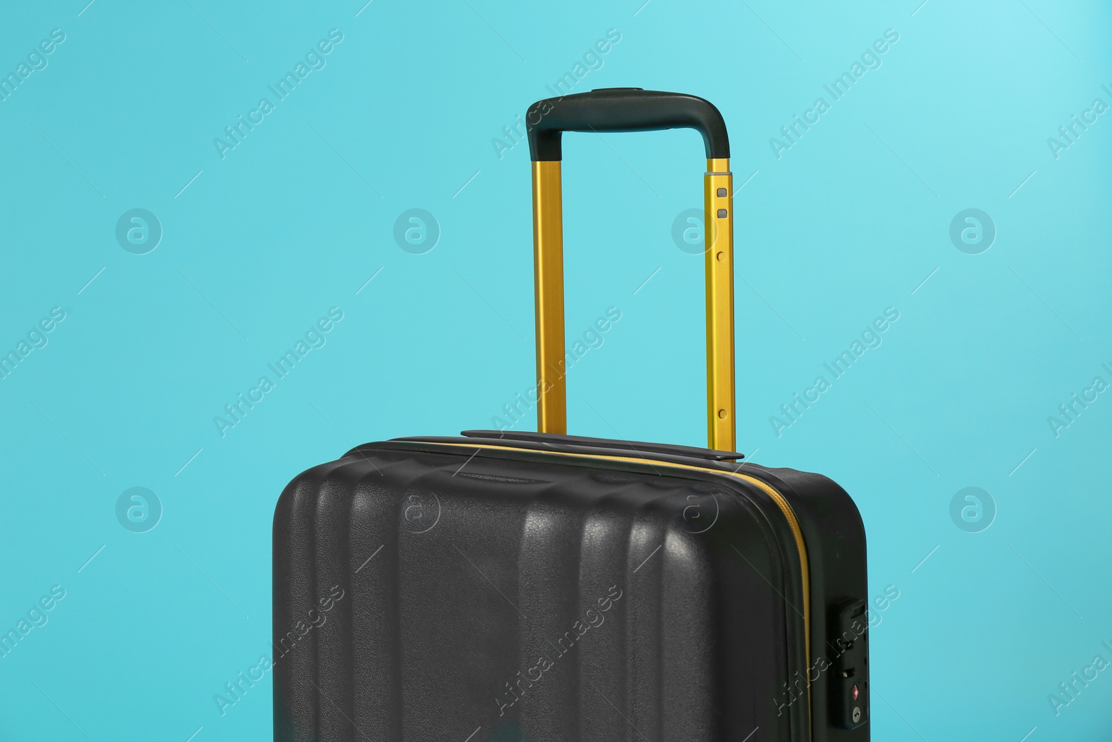 Photo of Stylish carry on suitcase on color background