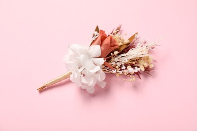 Photo of Stylish boutonniere on pink background. Beautiful accessory