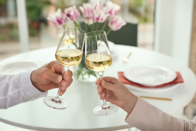 People with glasses of wine on blurred background, closeup