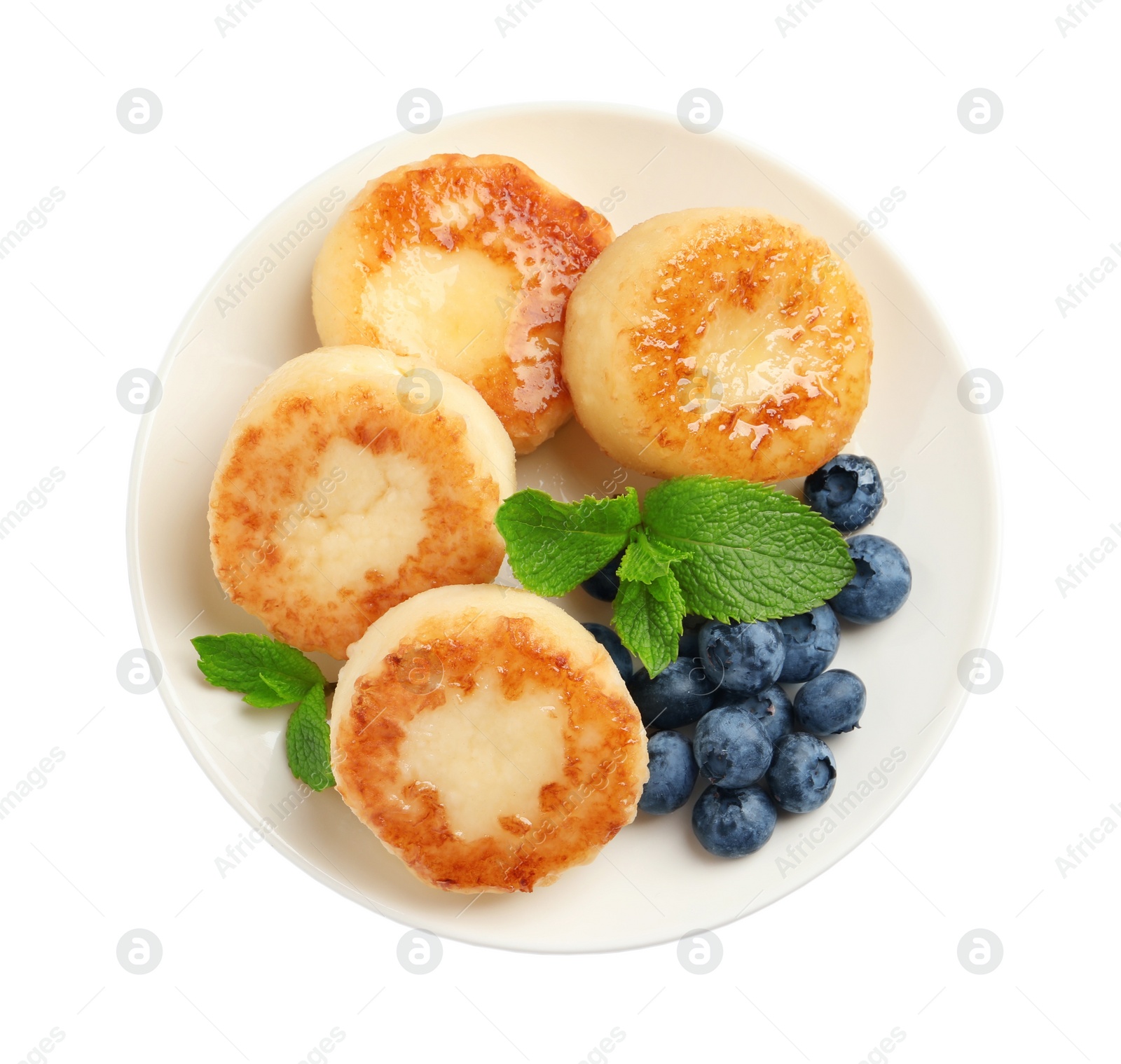 Photo of Delicious cottage cheese pancakes with blueberries, honey and mint on white background, top view