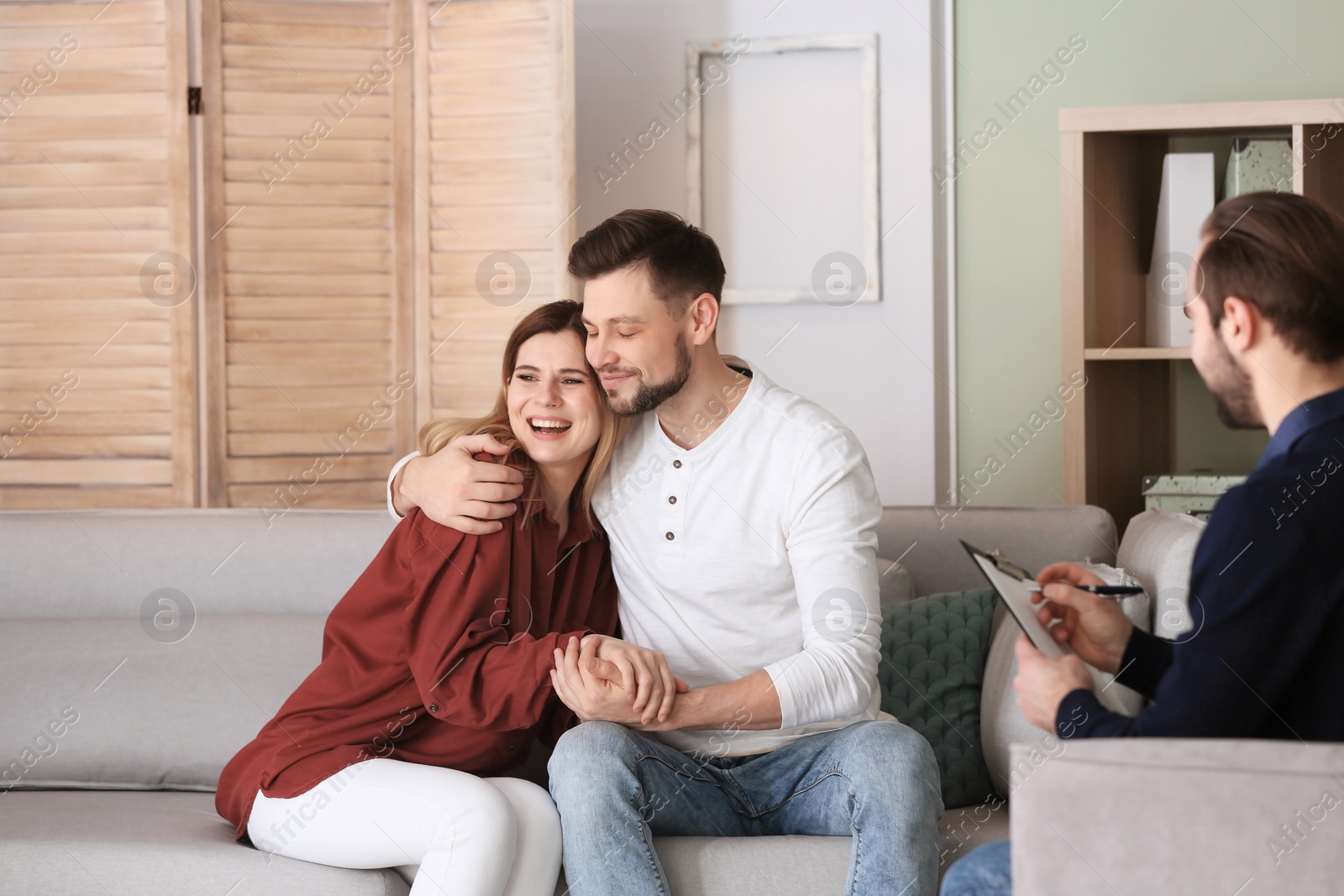 Photo of Family psychologist working with young couple in office