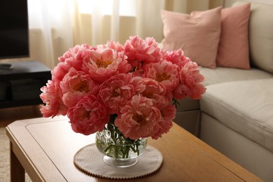 Beautiful pink peonies in vase on table at home. Interior design