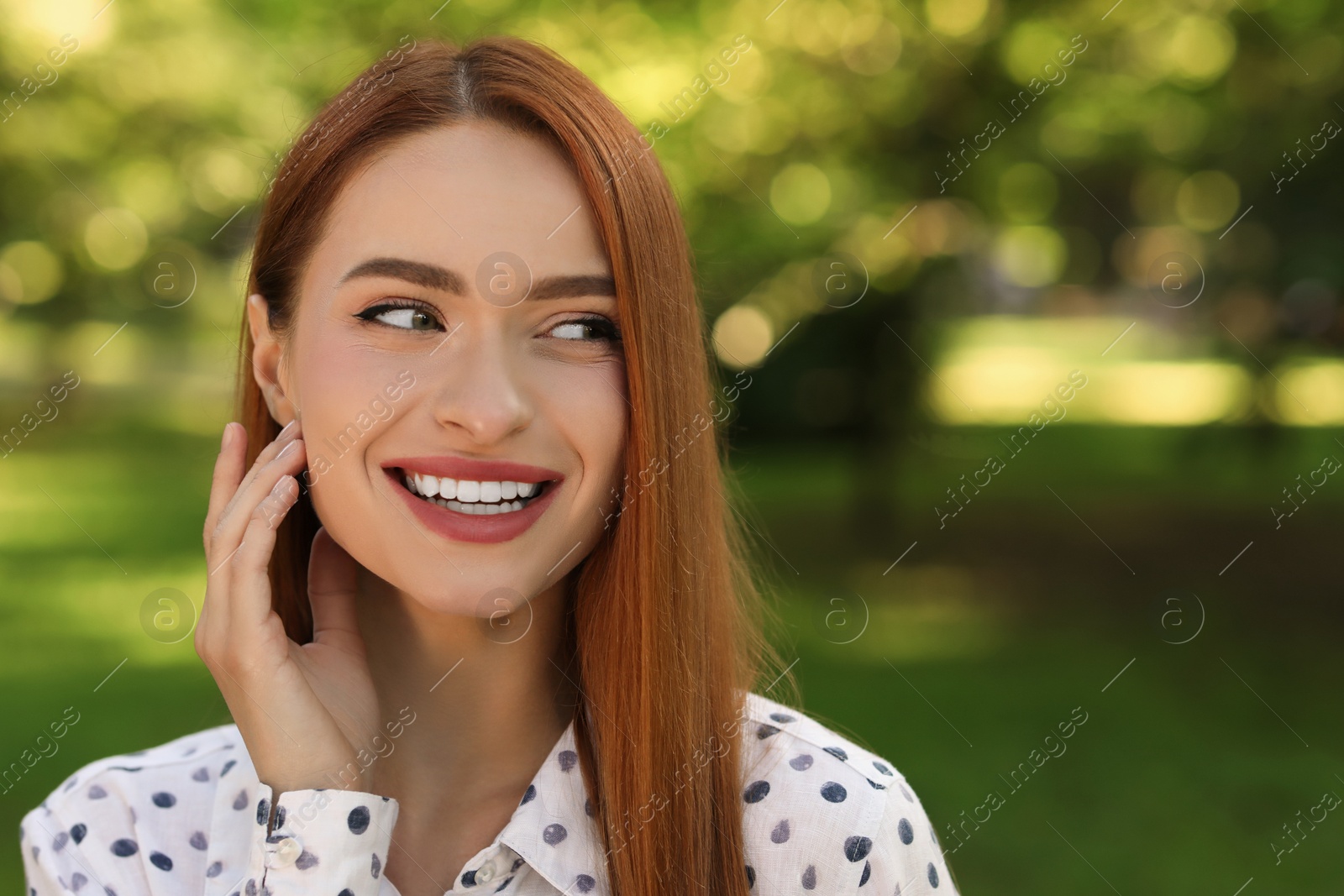Photo of Portrait of happy young woman outdoors. Space for text. Attractive lady smiling and posing for camera