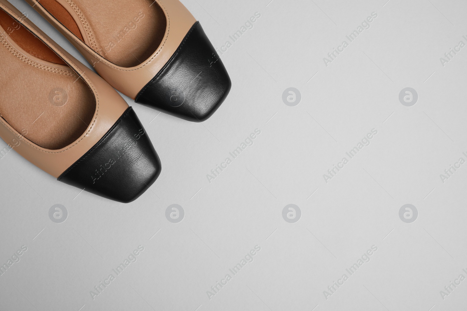 Photo of Pair of new stylish square toe ballet flats on light grey background, flat lay. Space for text