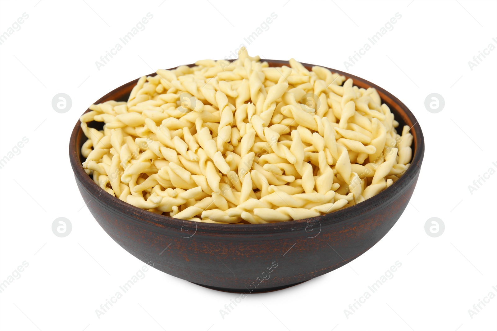 Photo of Uncooked trofie pasta in bowl isolated on white