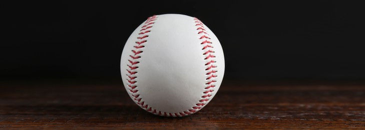 Image of Baseball ball on wooden table, banner design