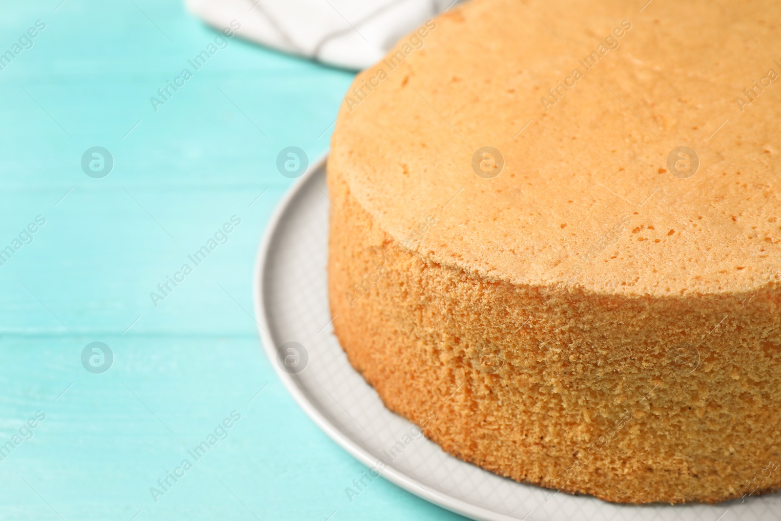 Photo of Delicious fresh homemade cake on light blue wooden table, closeup