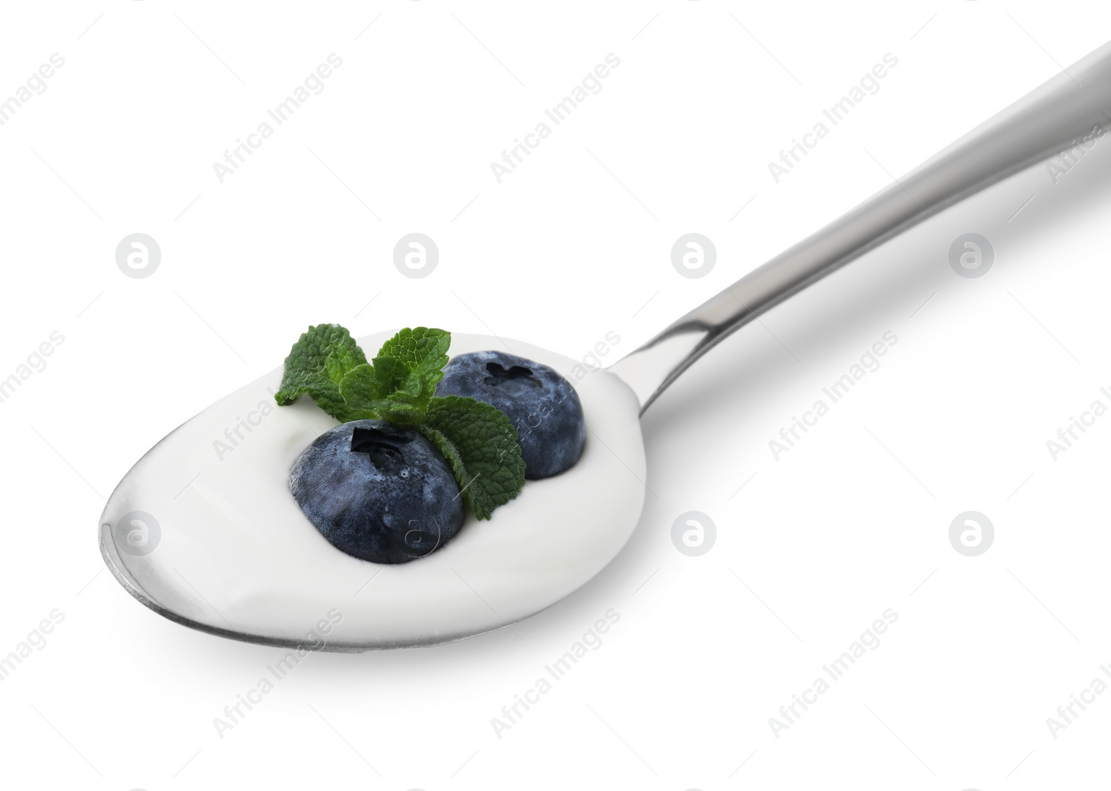 Photo of Spoon with yogurt, blueberries and mint isolated on white