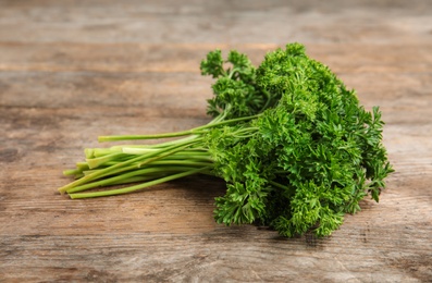 Bunch of fresh green parsley on wooden table