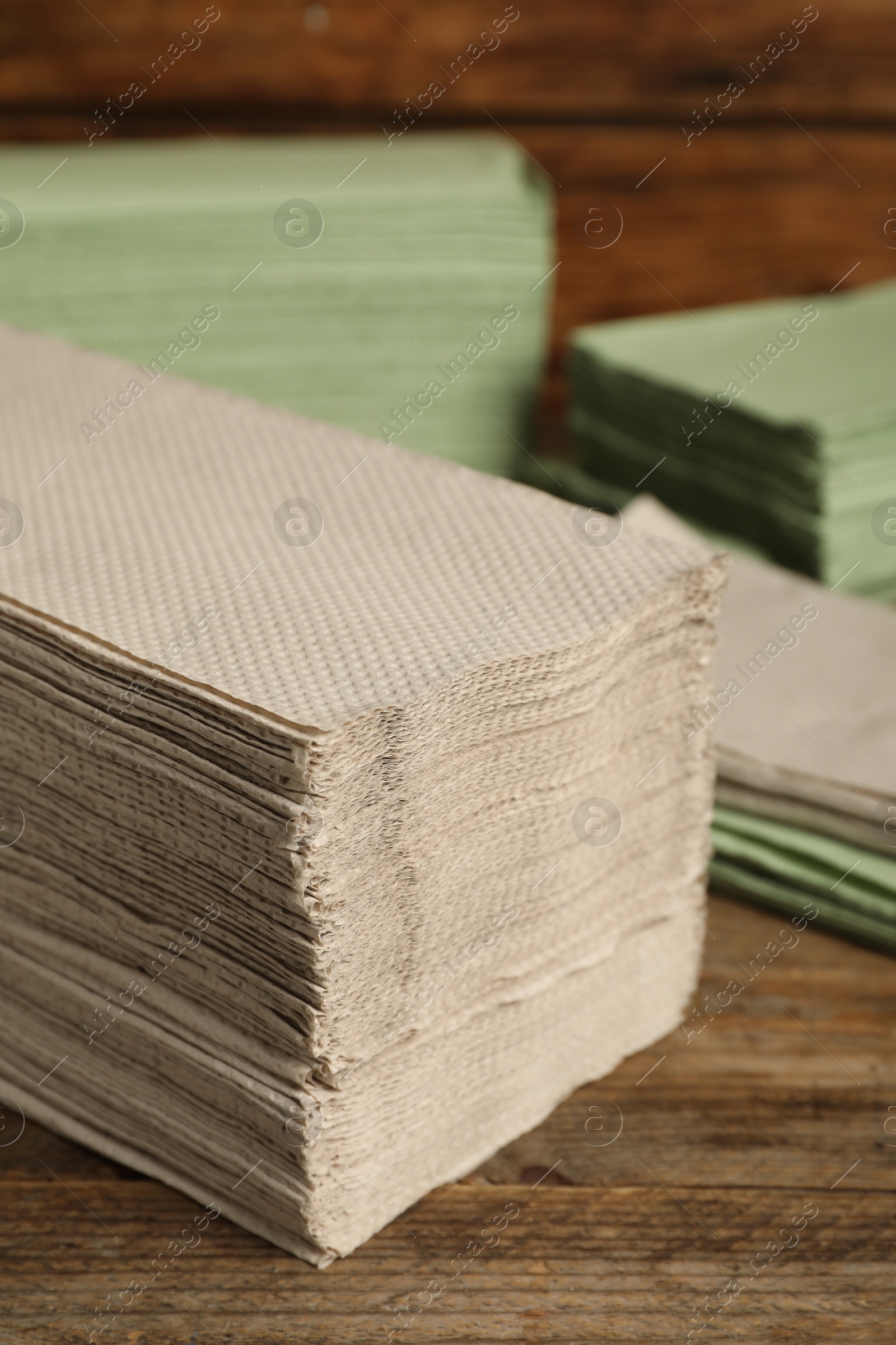 Photo of Many paper towles on wooden table, closeup