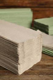 Many paper towles on wooden table, closeup