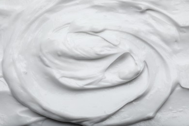 Closeup view of white body cream as background